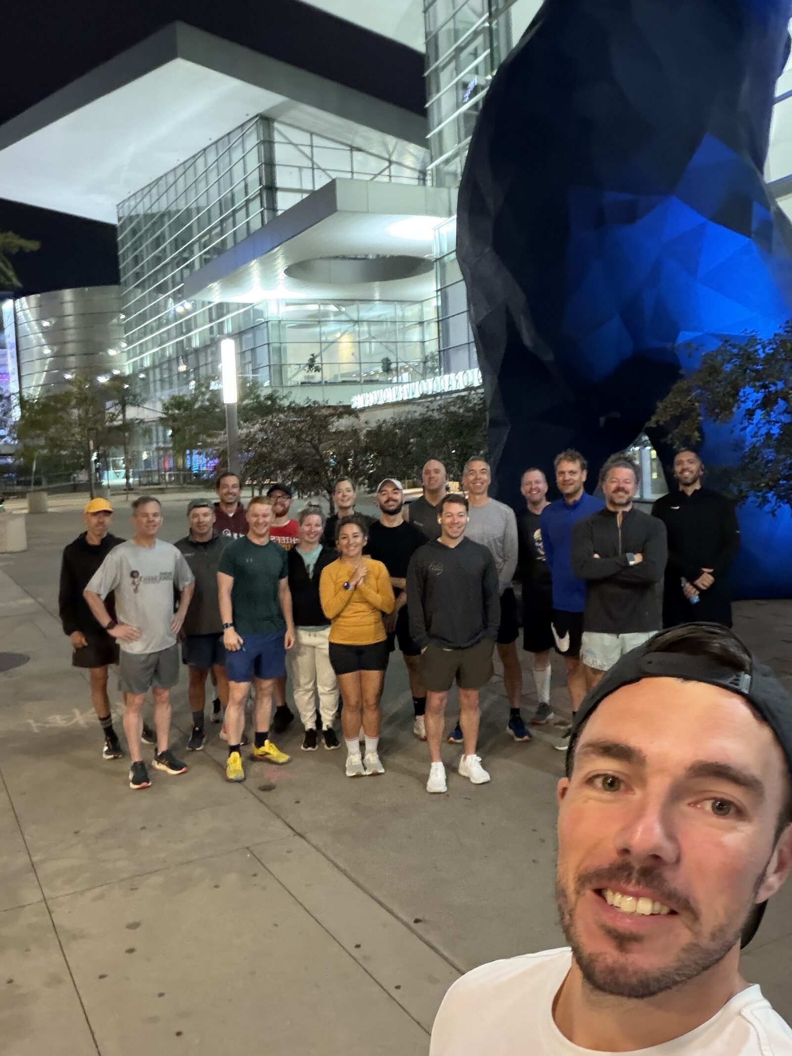 Last year's community run group — about twenty runners posing for a pre-dawn selfie outside the Denver convention center.
